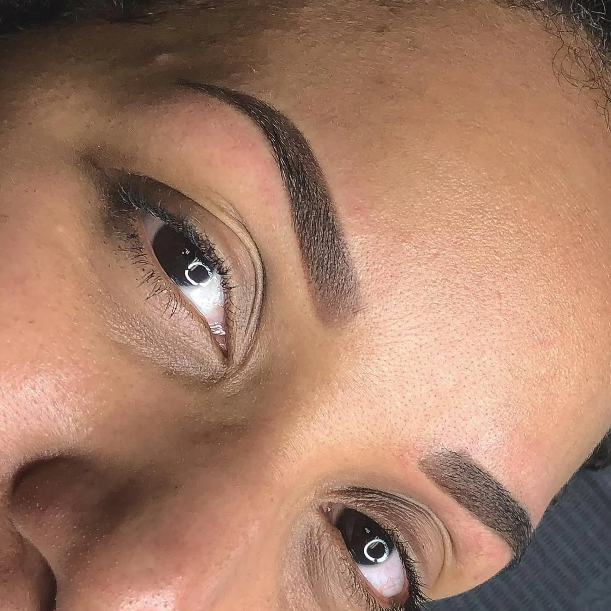 close-up of eyebrow tattooing process